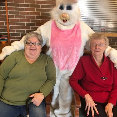 Residents posing with an Easter Bunny mascot