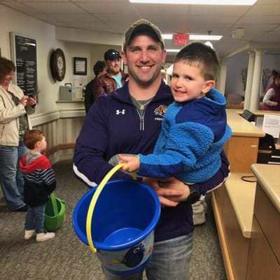 Adult holding a child in a facility's common area
