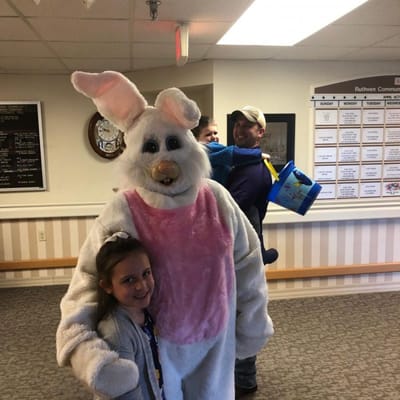 Children interacting with a staff member in a costume
