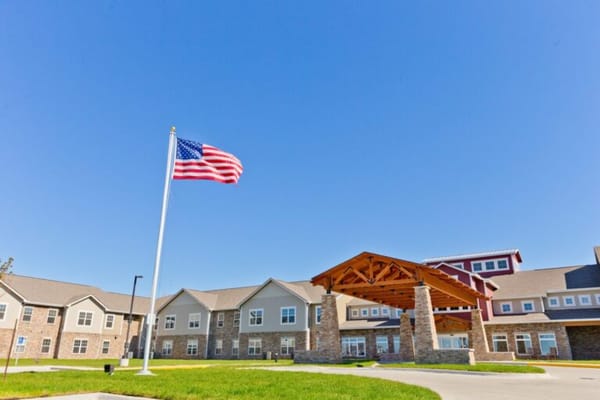 Exterior view of assisted living facility with flag