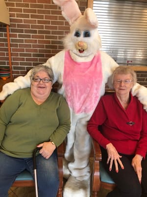 Residents posing with a festive Easter Bunny costume