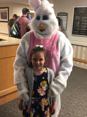 Child posing with Easter Bunny in the lobby