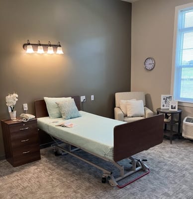 Private resident room with adjustable bed and seating area