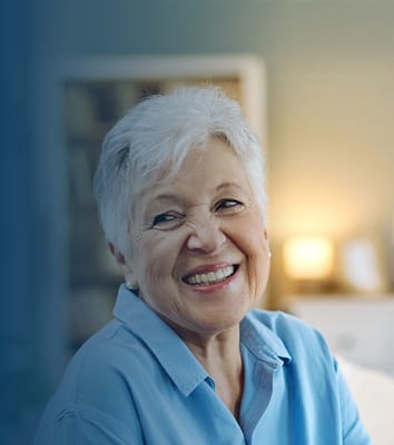 A smiling senior woman in a cozy setting