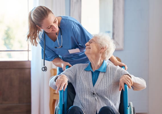 Nurse engaging with a smiling resident in a care facility