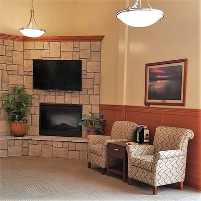 Cozy seating area with stone fireplace and TV