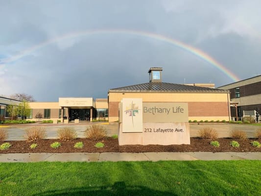 Front entrance of Bethany Life with a rainbow