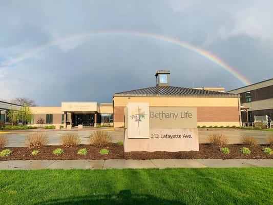 Front entrance of Bethany Life with a rainbow