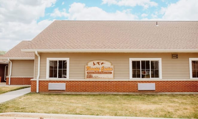 Exterior view of a nursing home facility with signage