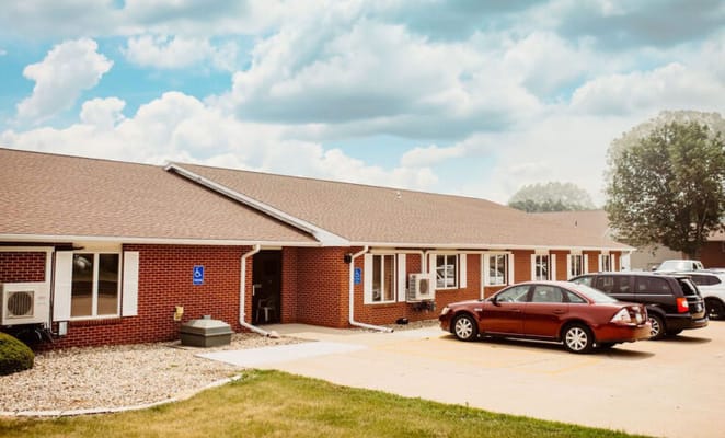 Exterior view of a senior living facility with parking