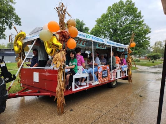 Residents enjoying a decorated hayride at a community event