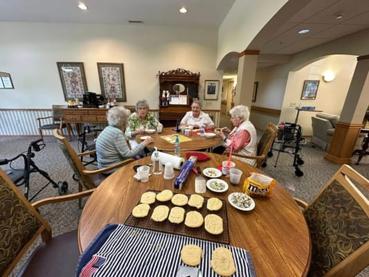 Residents enjoying a baking activity at a communal table