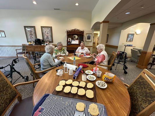 Residents enjoying a baking activity at a communal table