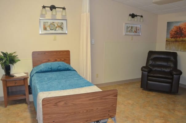 Private resident room with a bed and armchair