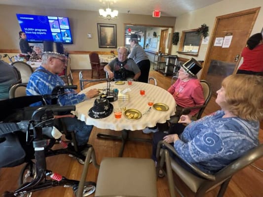 Residents celebrating together at a table during an activity