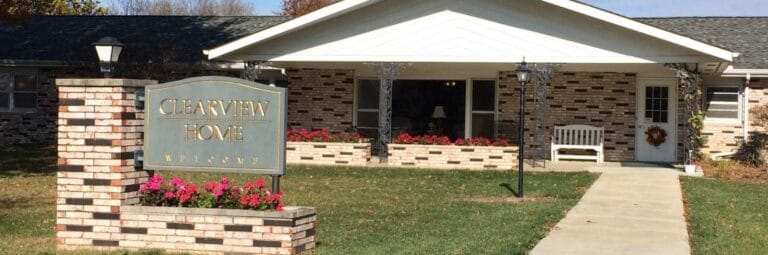 Exterior view of Clearview Home with flower beds