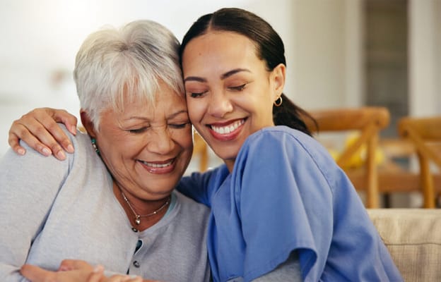 A caregiver and resident sharing a joyful moment