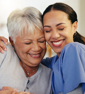 A caregiver and resident sharing a joyful moment