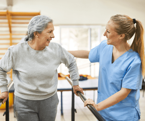 Resident and caregiver interacting in an activity room