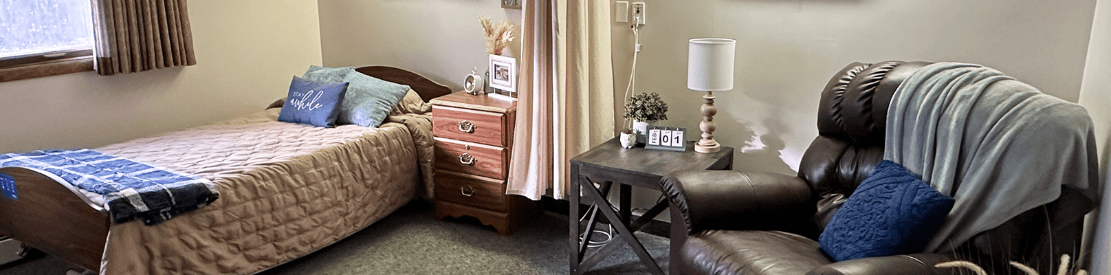 Cozy resident room with a bed and chair