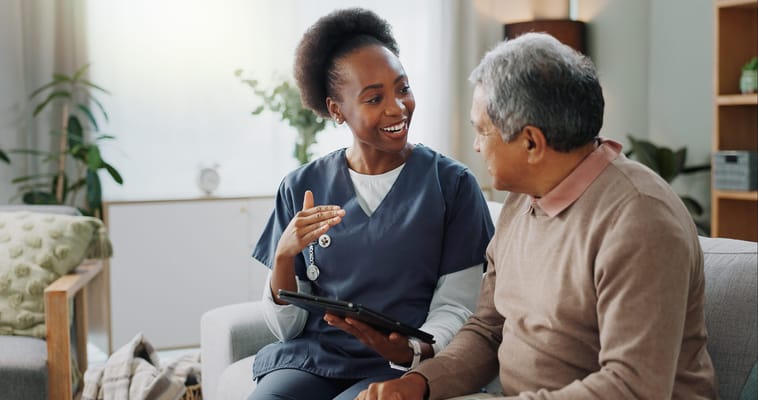 Staff member discussing with a resident in a cozy setting