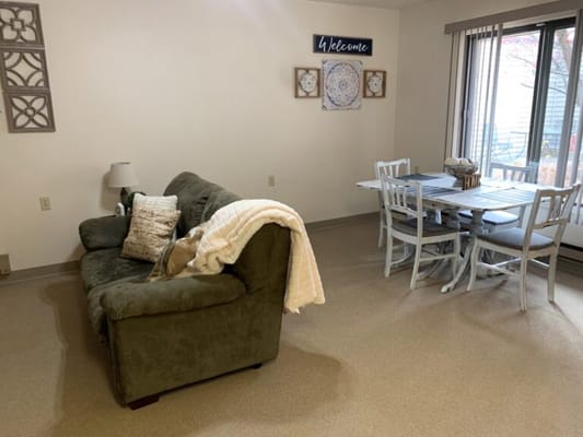Cozy interior of a resident's room with seating and dining area