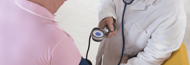 Healthcare professional taking a resident's blood pressure