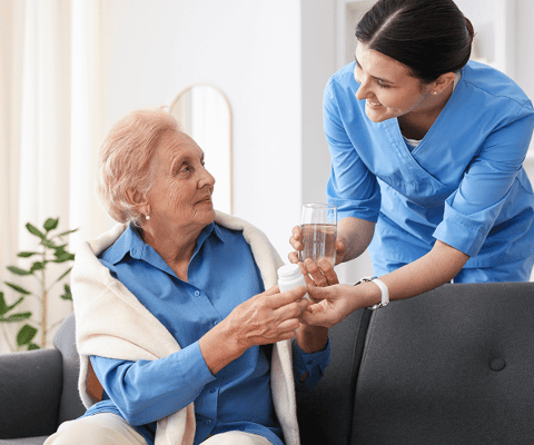 Caregiver assisting a resident with medication
