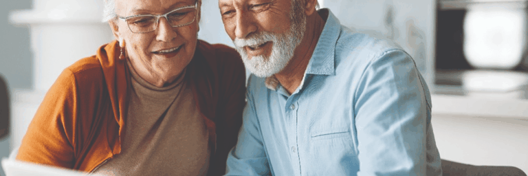 Senior couple enjoying time together with a laptop