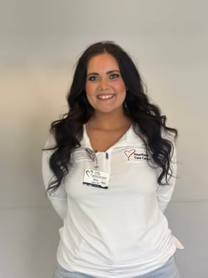 Staff member posing with a name badge