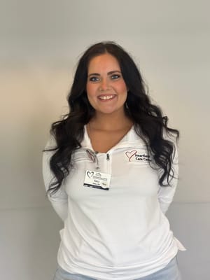 Staff member posing with a name badge