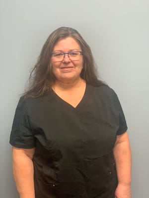 Staff member posing for a photo in a uniform