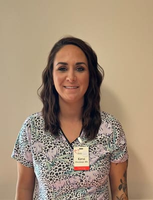 Nurse posing for a photo wearing scrubs