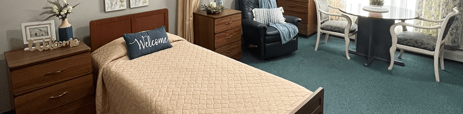 Cozy interior of a resident room with a bed and table