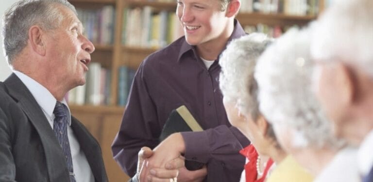 Residents interacting with a staff member in a common area