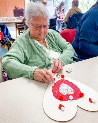 Resident crafting decorations during an activity session