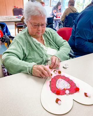 Resident crafting decorations during an activity session