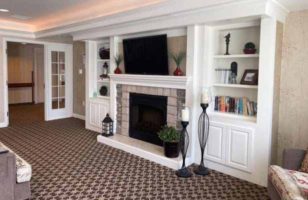 Cozy common area with a fireplace and bookshelves