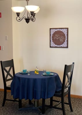 Dining table set for two with blue dinnerware