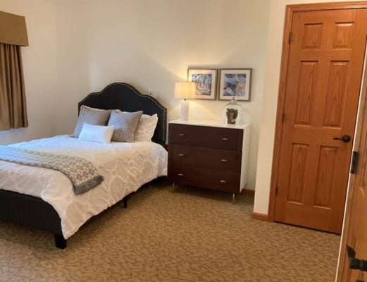 Cozy private bedroom with a bed and nightstand