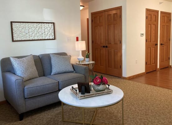 Cozy living area with gray couch and decorative table
