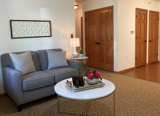 Cozy living area with gray couch and decorative table
