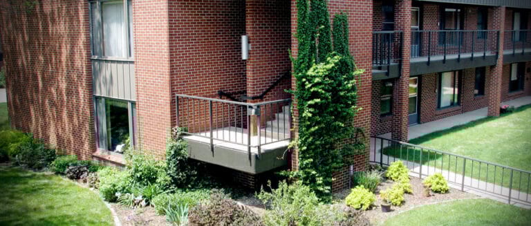 Exterior view of a senior living building with landscaping