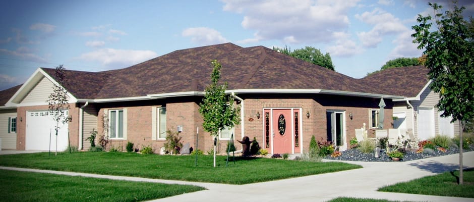 Exterior view of a senior living facility with landscaped grounds