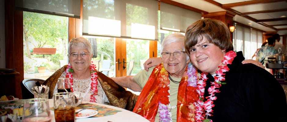Residents enjoying a festive meal with a young visitor