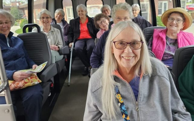 Residents enjoying a van ride to an outing