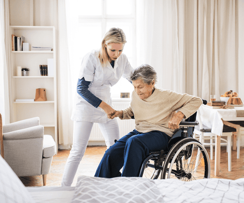 Caregiver assisting a resident in a bright room