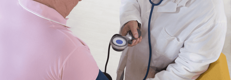 Healthcare professional checking resident's blood pressure