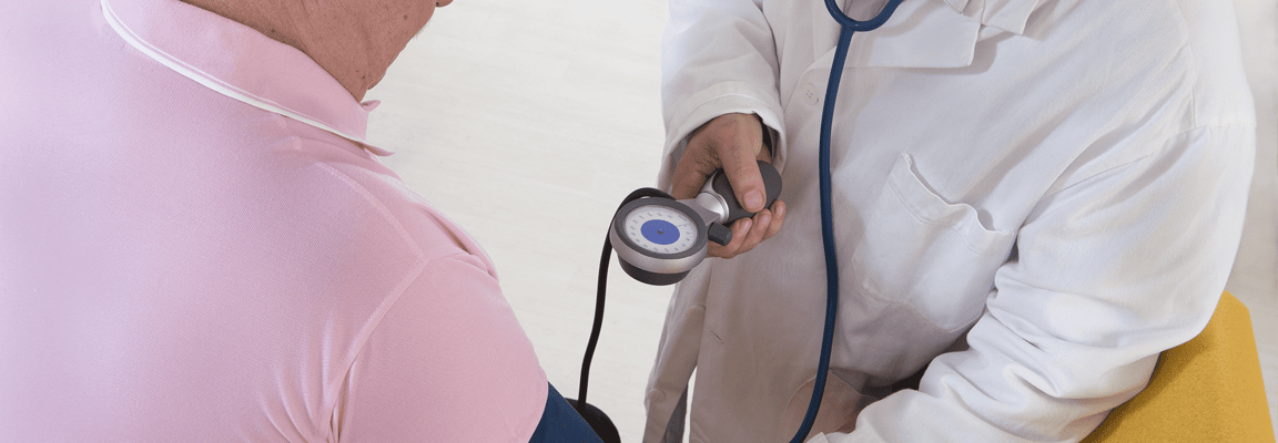 Healthcare professional checking resident's blood pressure