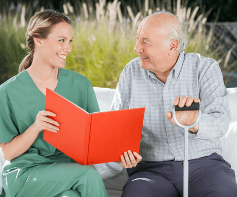 Staff member and resident sharing a conversation outdoors